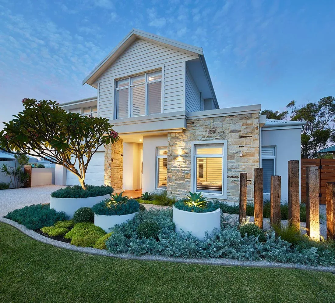 Two-storey home front yard landscape design with sandstone cladding, timber feature posts and a curved lawn edge