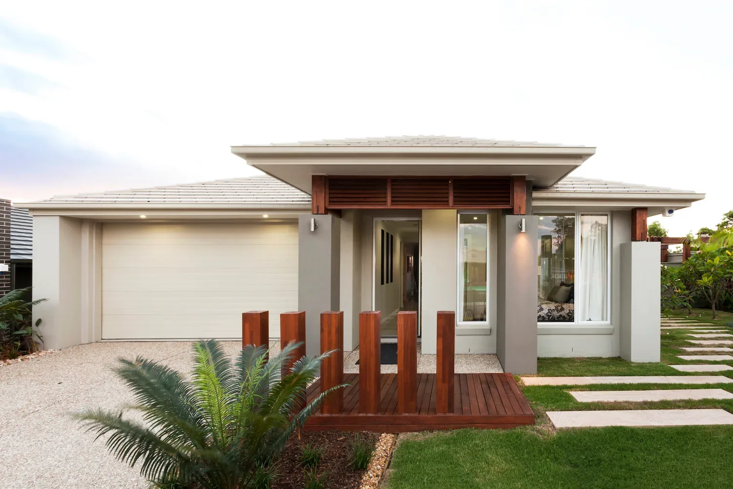 Small elevated timber deck entry feature with vertical timber posts on a modern house facade